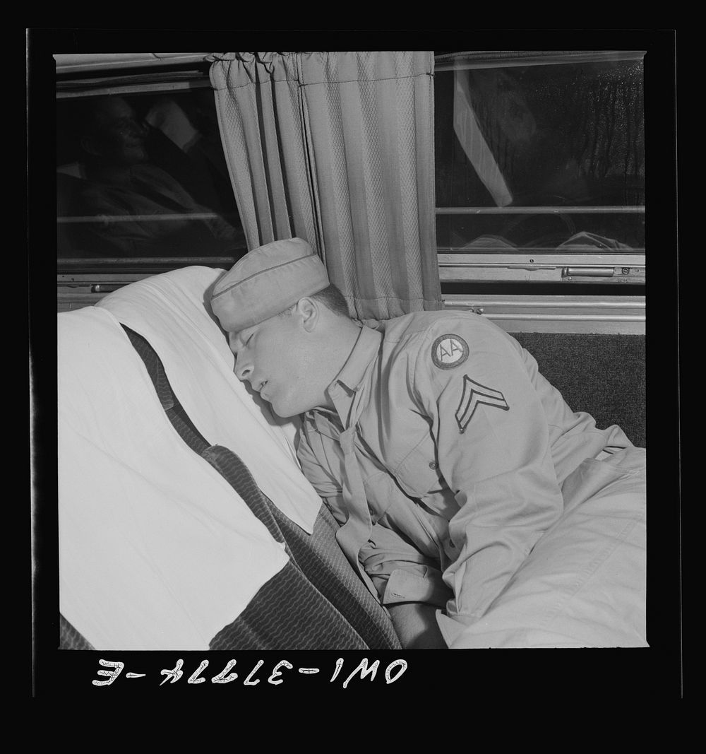 A soldier sleeping on the way from Cincinnati, Ohio to Louisville, Kentucky on a Greyhound bus. Sourced from the Library of…