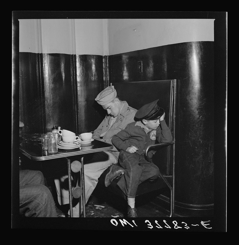 Louisville, Kentucky. Bus passengers sleeping in a booth in the lunchroom of the Greyhound bus terminal at 3 a.m., since all…