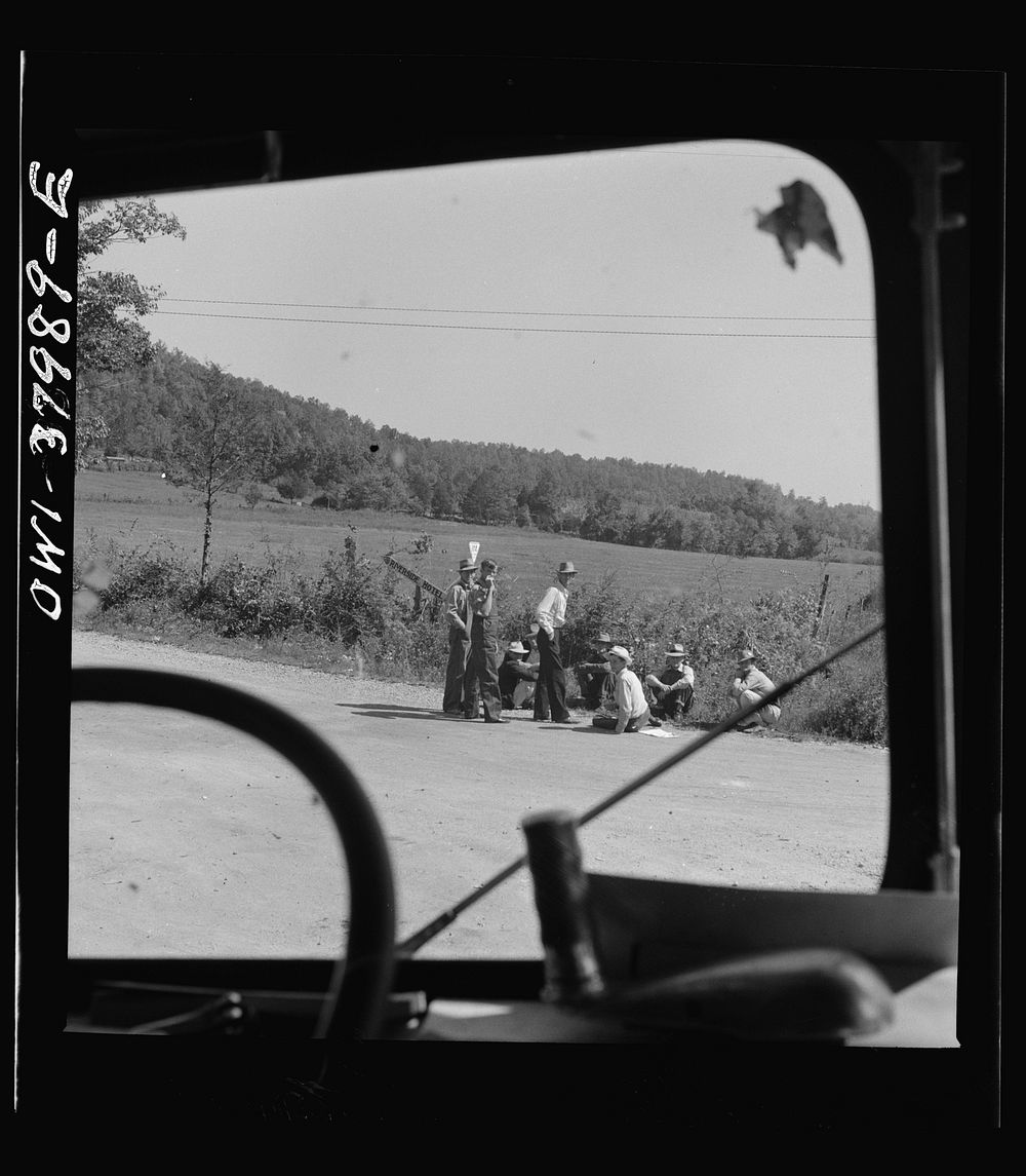 A Greyhound bus trip from Louisville, Kentucky, to Memphis, Tennessee, and the terminals. Men sitting by road side on Sunday…