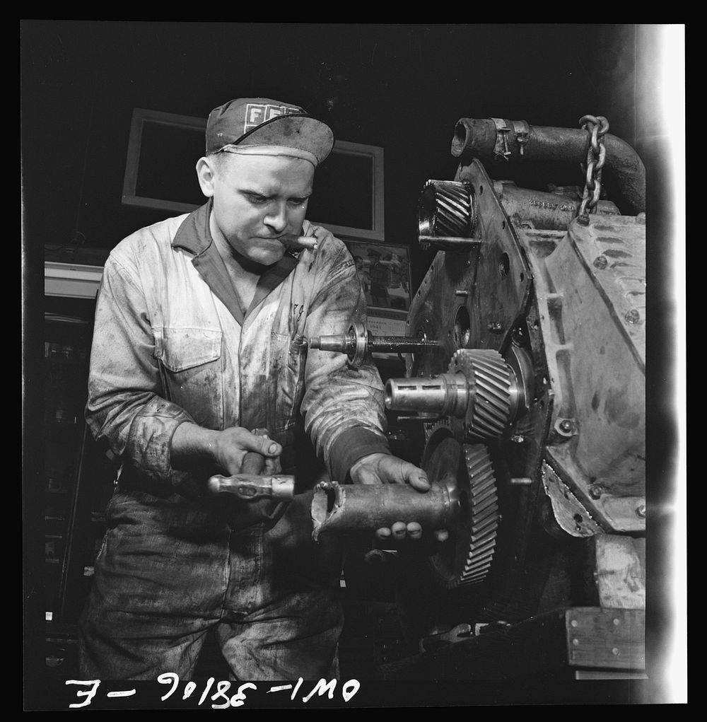 Bus trip from Knoxville, Tennessee, to Washington, D.C. Mechanic rebuilding bus motor at the garage of the Tennesse Coach…
