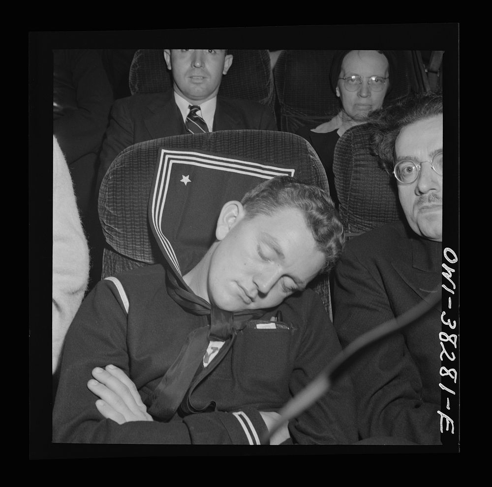 A sailor asleep on a bus enroute from Roanoke, Virginia to Washington, D.C.. Sourced from the Library of Congress.