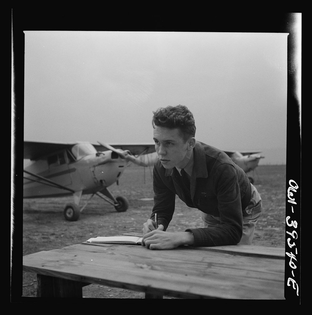 Frederick, Maryland. Walter Spangenberg, a student at Woodrow Wilson High School, filling out his pilot's log book at the…