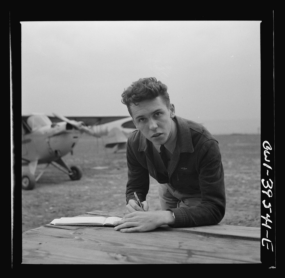 Frederick, Maryland. Walter Spangenberg, a student at Woodrow Wilson High School, filling out his pilot's log book after a…