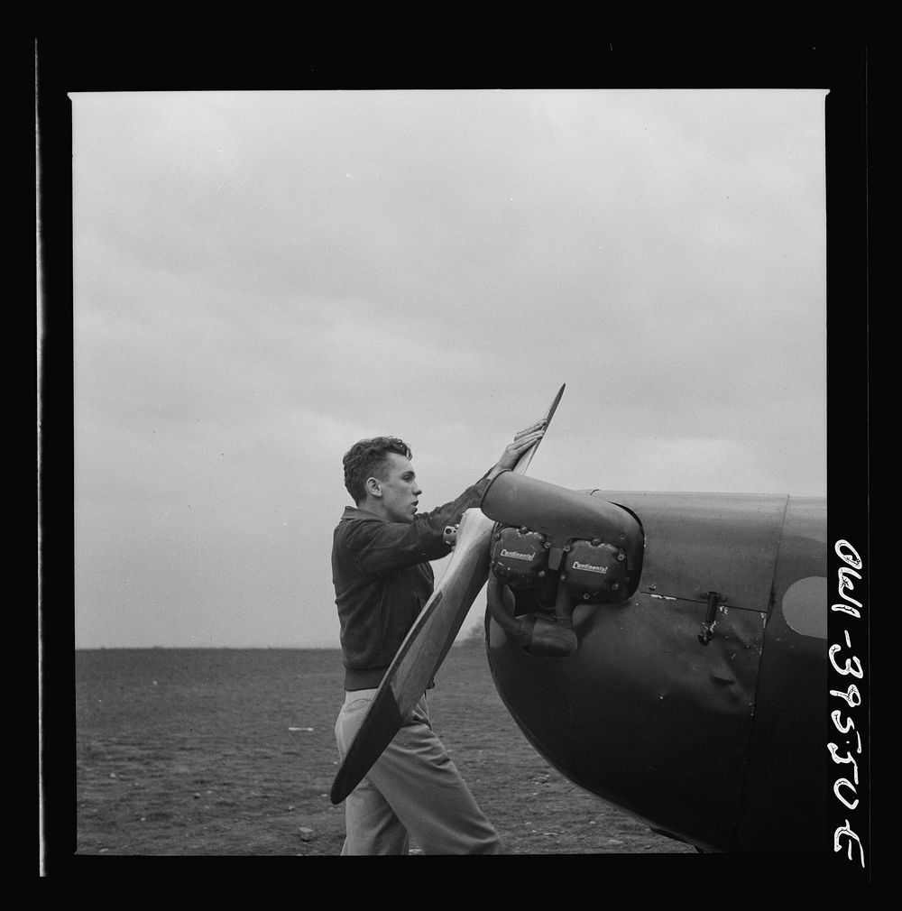 Frederick, Maryland. Walter Spangenberg, a student at Woodrow Wilson High School, spinning the propeller for a fellow…