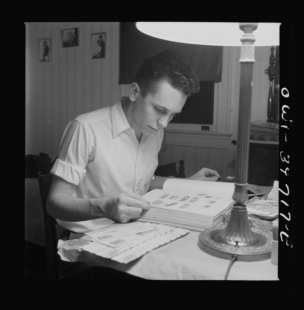 Washington, D.C. Walter Spangenberg, a student at Woodrow Wilson High School, working on his stamp collection. Sourced from…