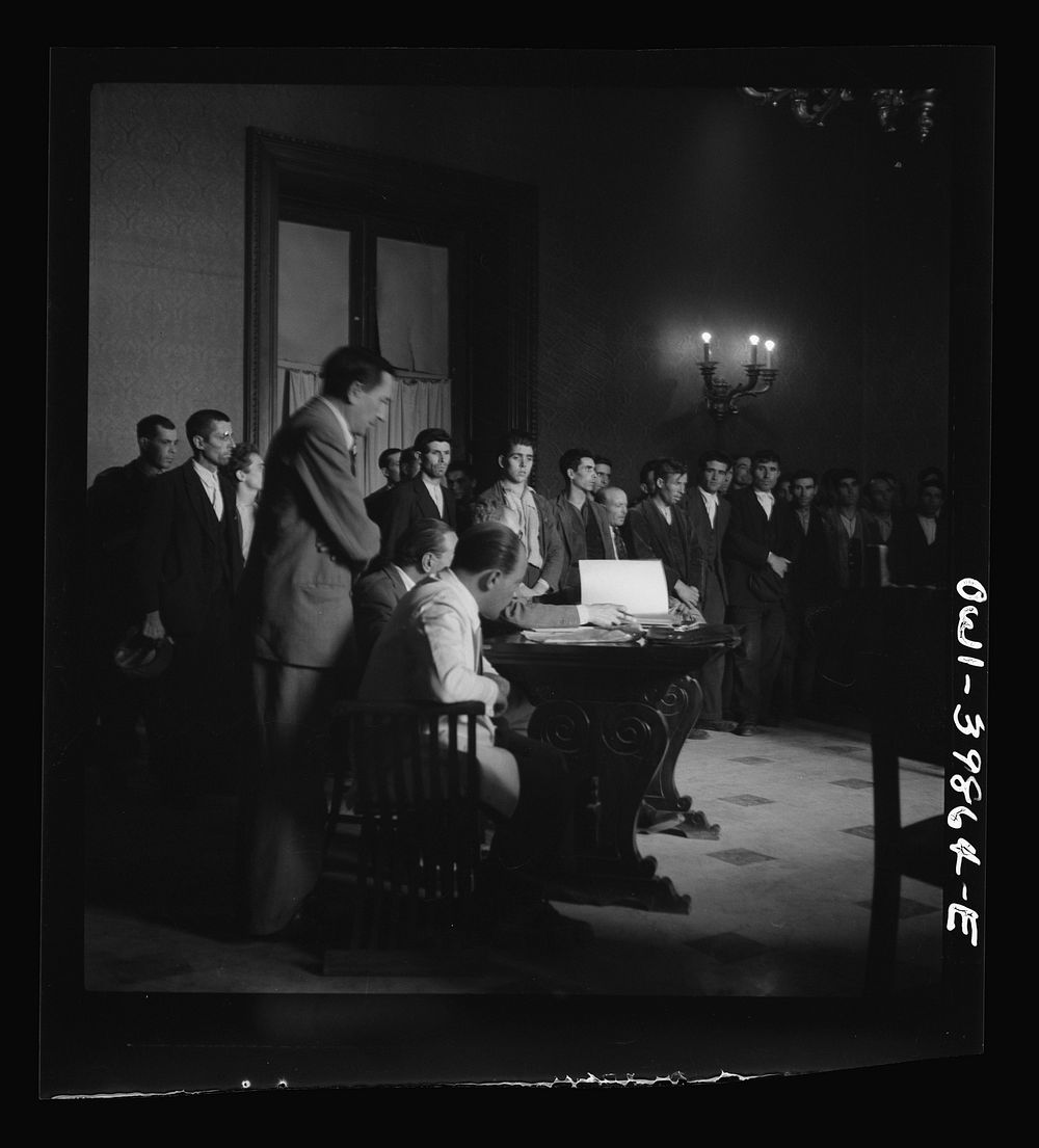 Sicilian civilians being tried in a court composed of two American majors and one Royal Air Force squadron leader. They were…