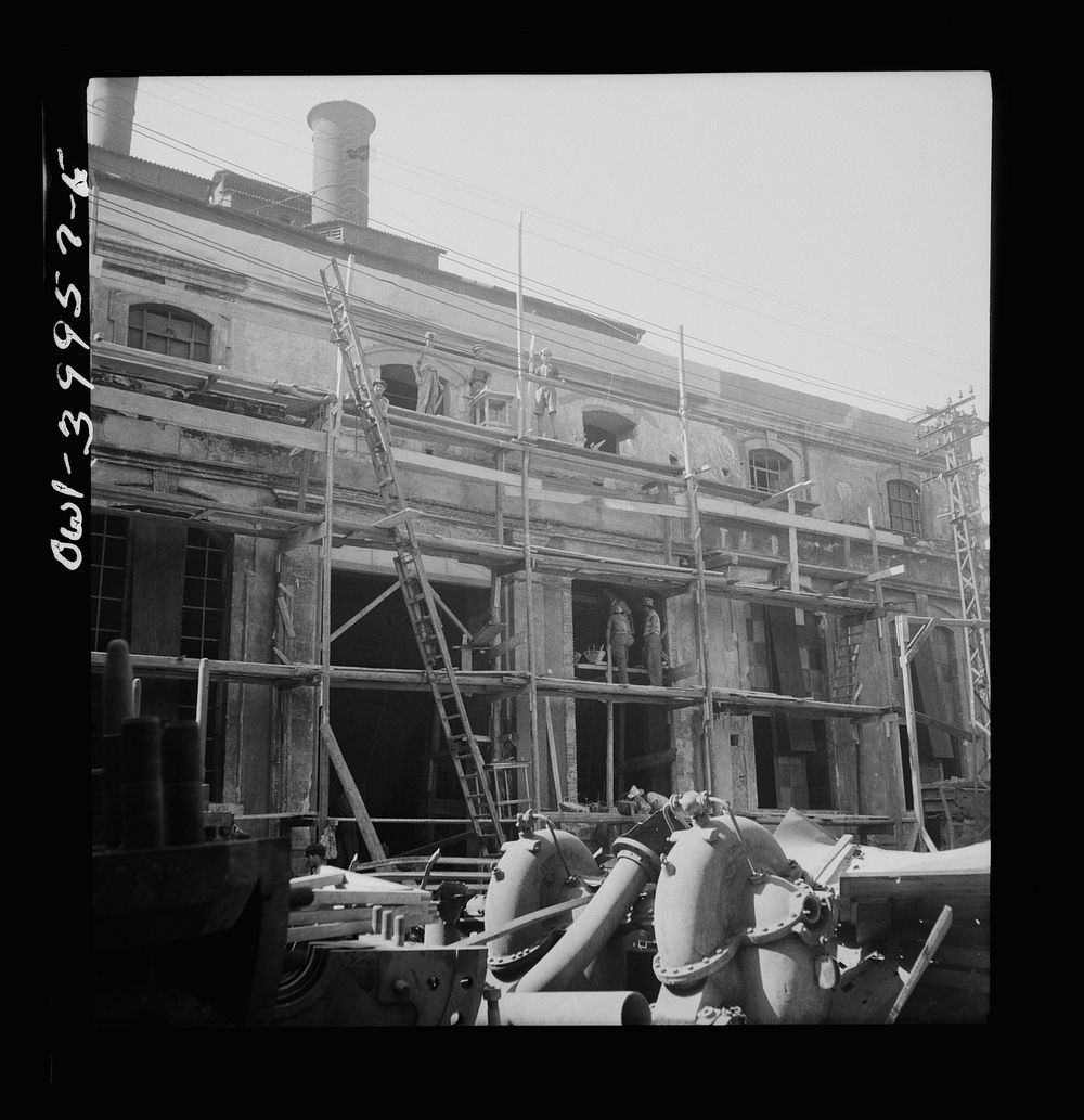 Catania, Sicily. Rebuilding the city. Wages comparable with peacetime are being paid by the Allied government. This money is…