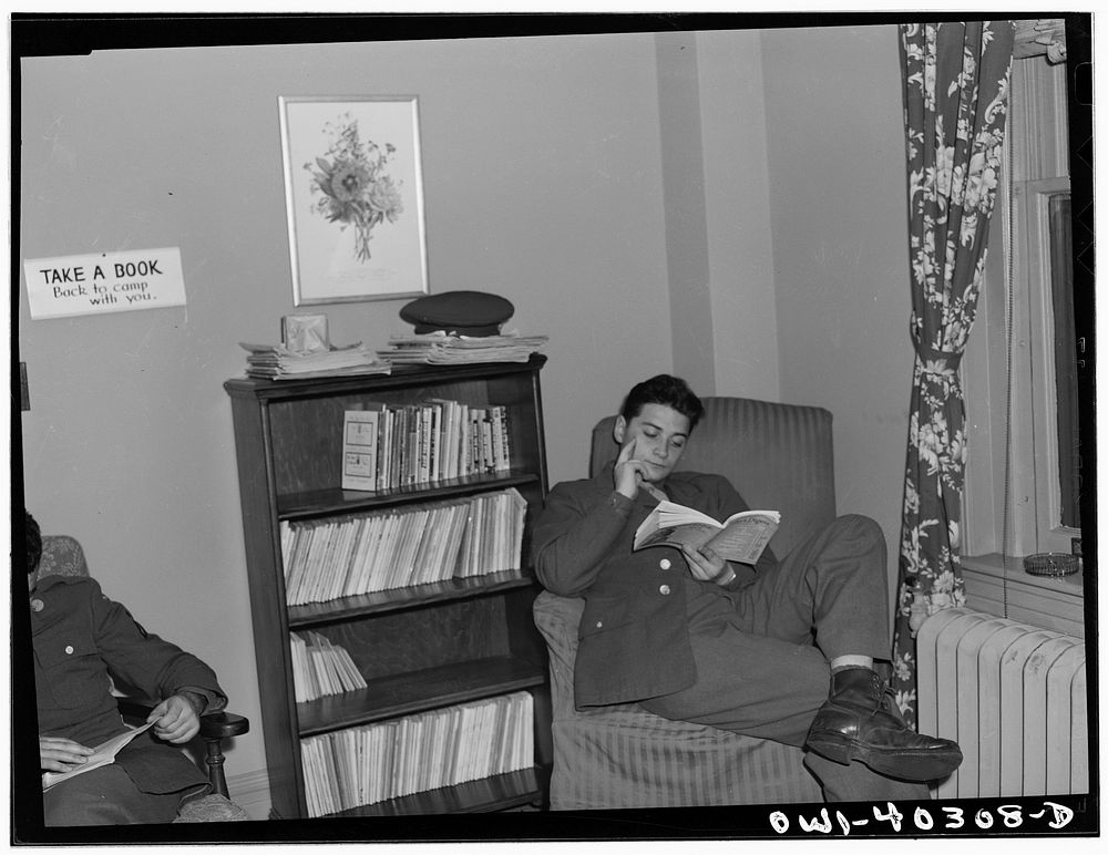 [Untitled photo, possibly related to: Washington, D.C. In the library at the United Nations service center. Boys are urged…