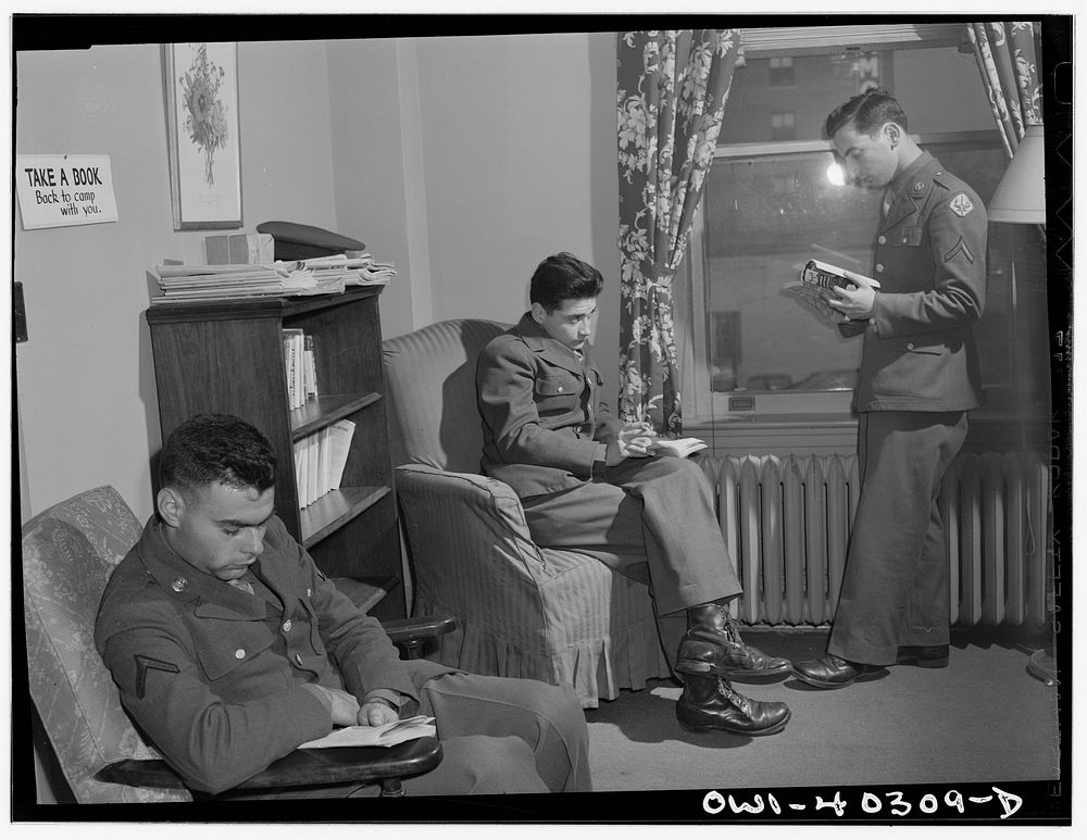 Washington, D.C. In the library at the United Nations service center. Boys are urged to take books back to camp with them.…