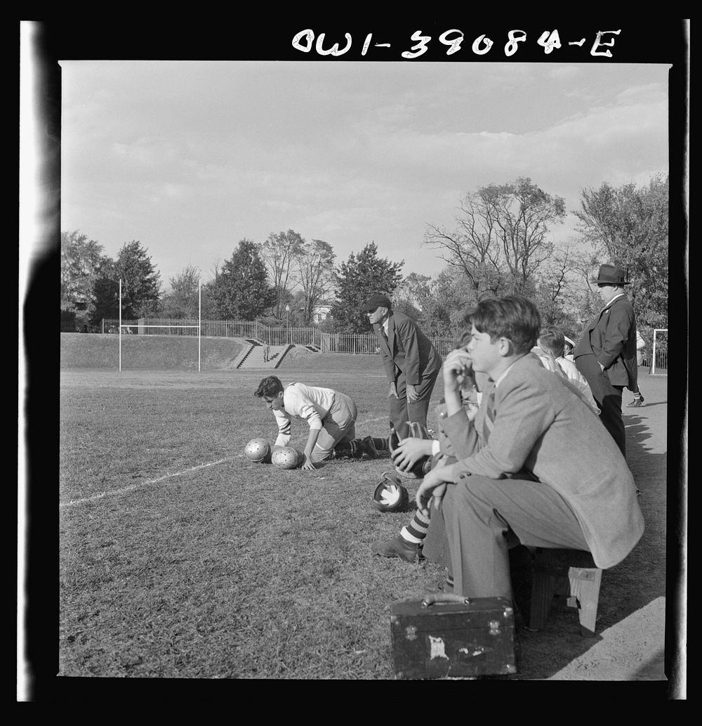 Washington, D.C. Woodrow Wilson High School manager watching a football game from the sidelines. Sourced from the Library of…