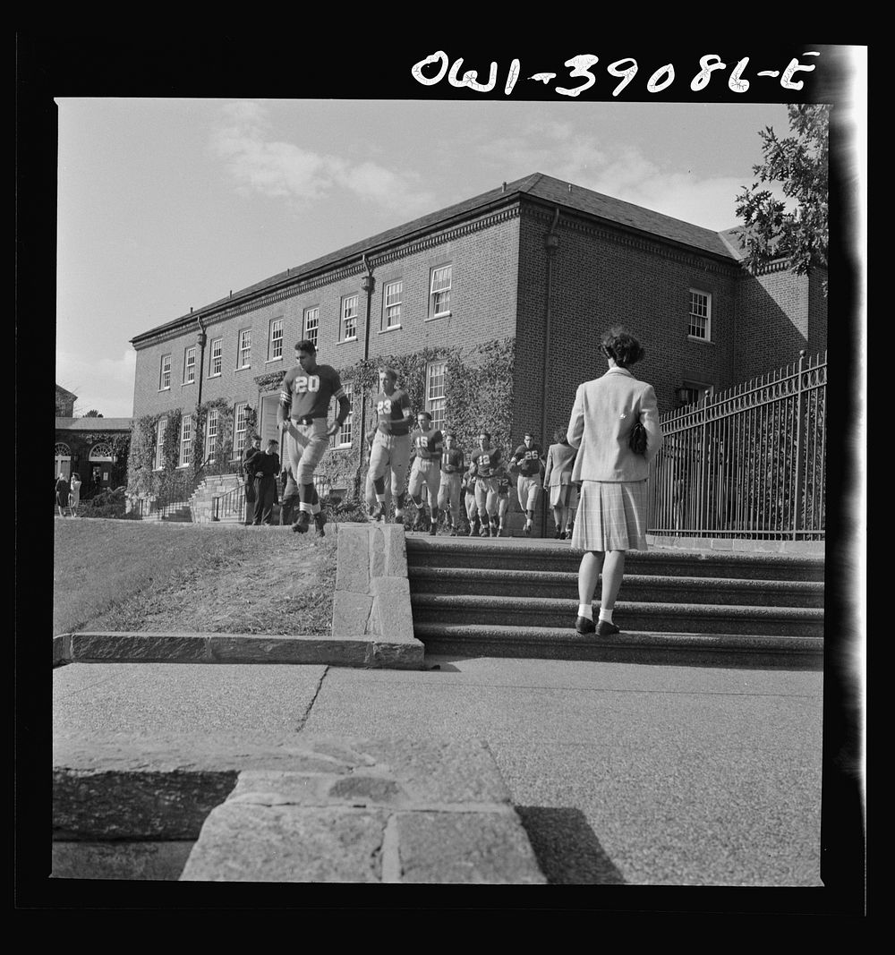 Washington, D.C. The team coming on the field at a Woodrow Wilson High School football game. Sourced from the Library of…