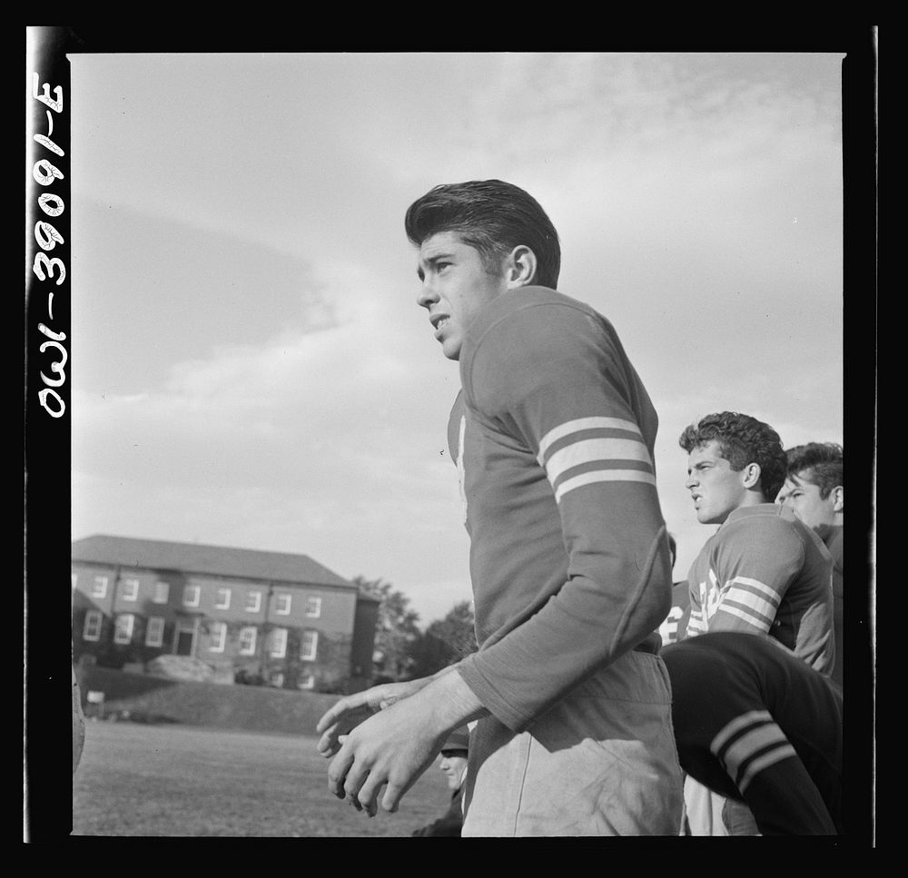 Washington, D.C. Members of the Woodrow Wilson High School football team watching a game from the sidelines. Sourced from…
