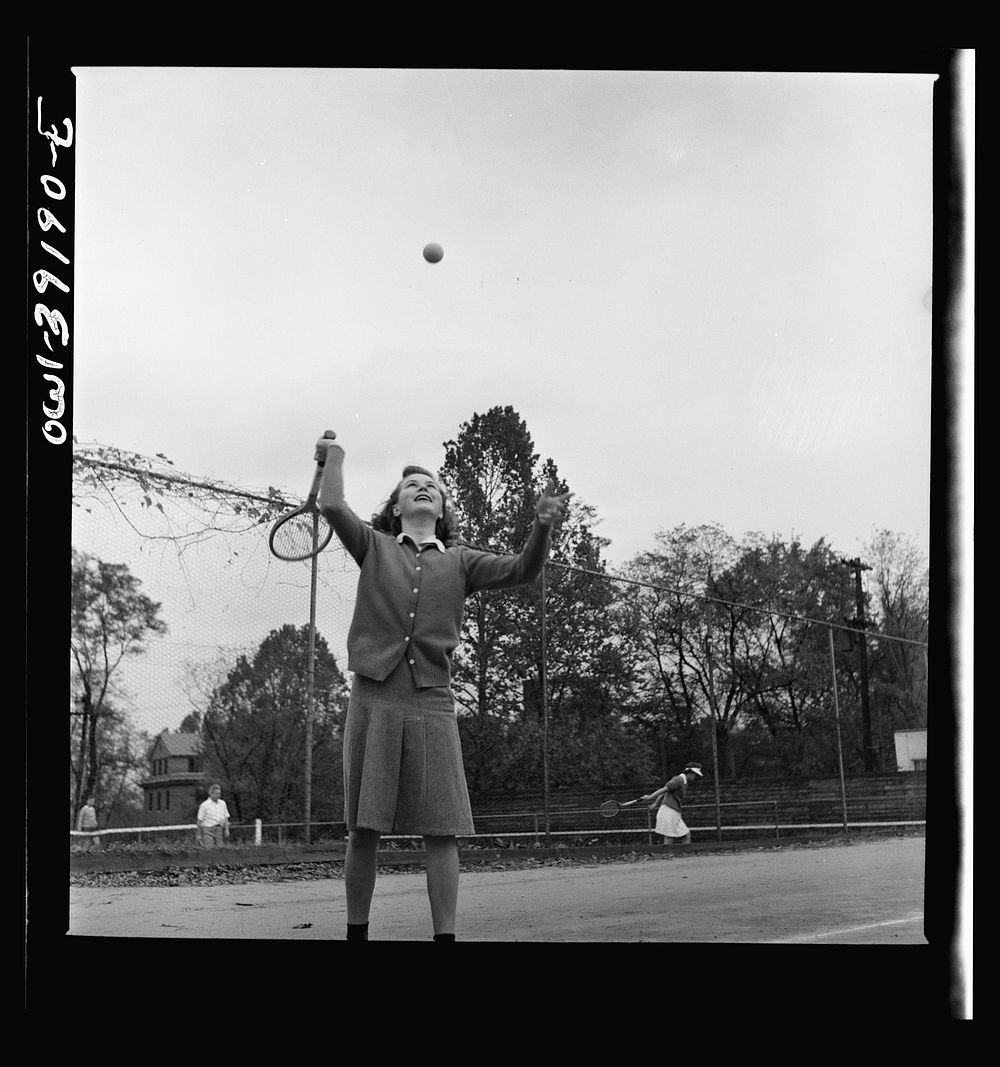 Washington, D.C. A Woodrow Wilson High School student playing tennis at a court near the school. Sourced from the Library of…