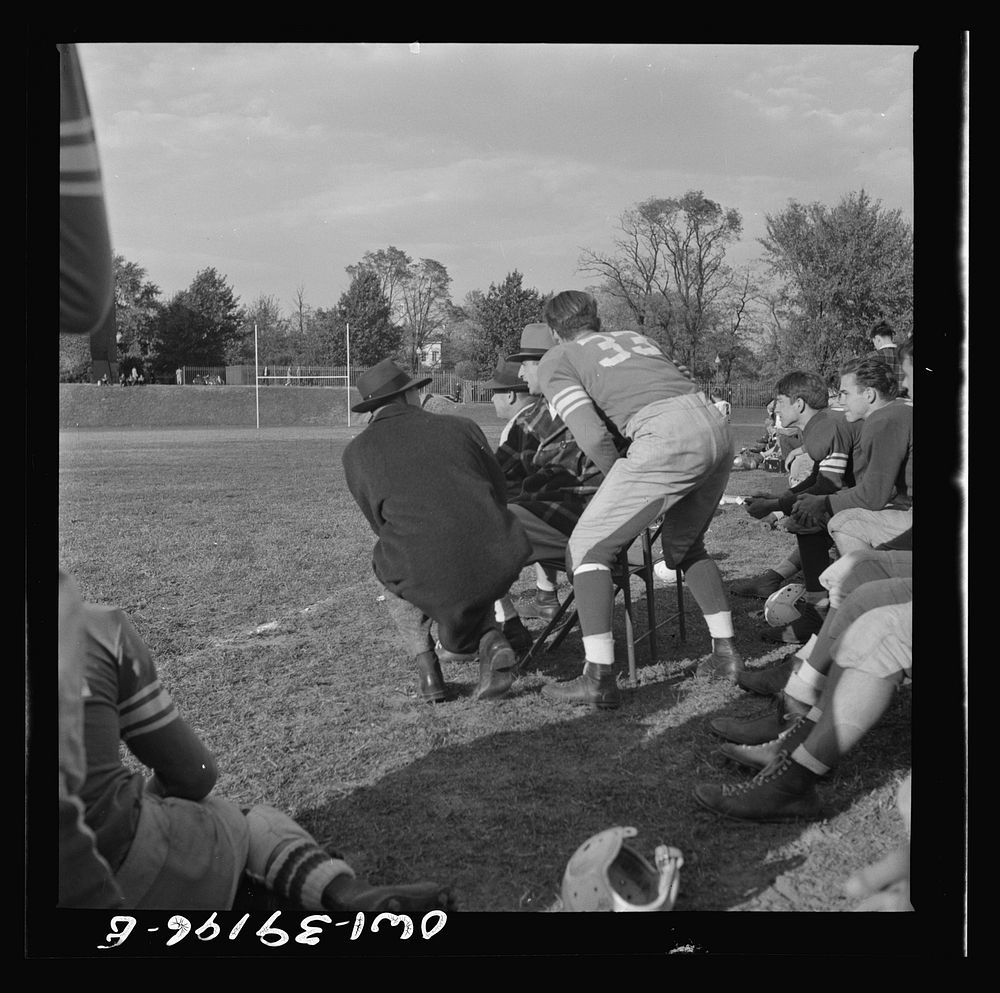 Washington, D.C. A football player at Woodrow Wilson High School getting instructions from the coach before going into the…