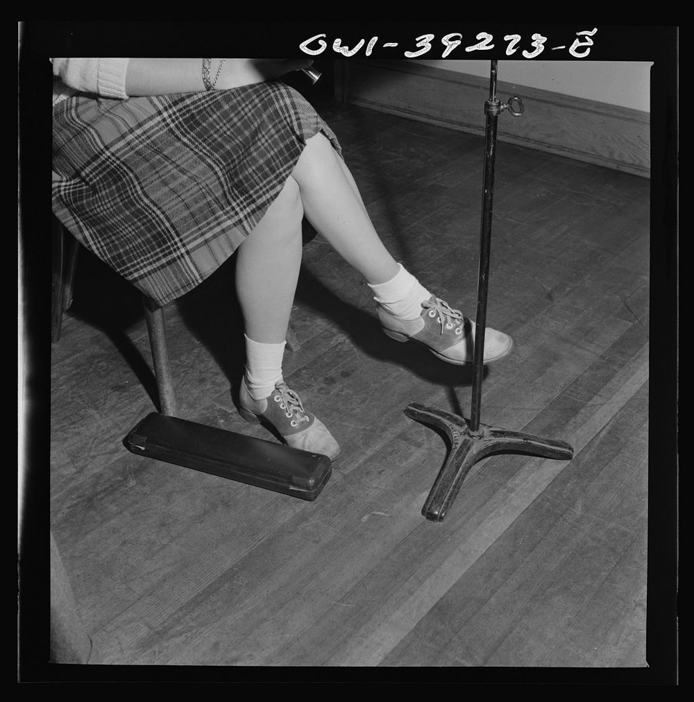Washington, D.C. The feet of a flute player in the Woodrow Wilson High School orchestra. Sourced from the Library of…