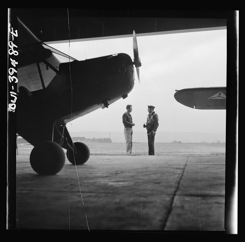 Frederick, Maryland. Walter Spangenberg, a student at Woodrow Wilson High School, talking to a friend at the Stevens Airport…