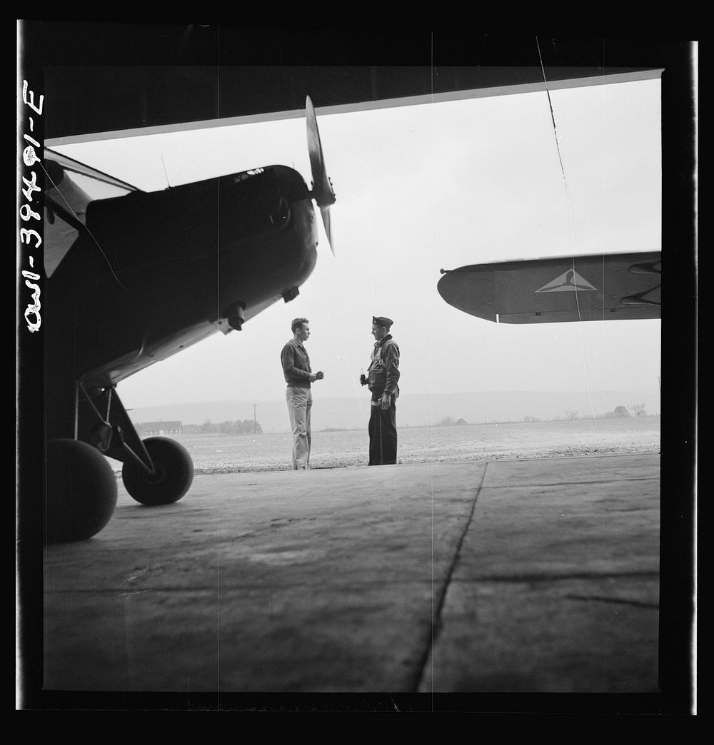 Frederick, Maryland. Walter Spangenberg, a student at Woodrow Wilson High School, talking to a friend at the Stevens Airport…
