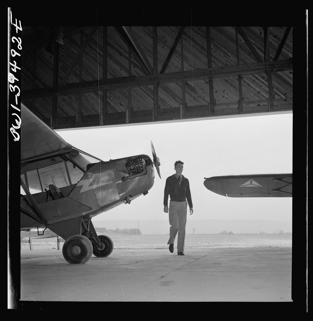 Frederick, Maryland. Walter Spangenberg, student at Woodrow Wilson High School, entering the hanger at the Stevens Airfield…