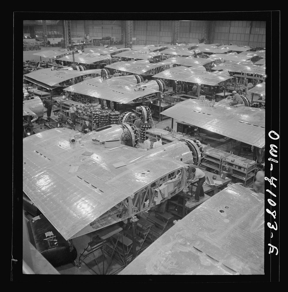 Boeing aircraft plant, Seattle, Washington. Production of B-17F (Flying Fortress) bombing planes. Wing section, each…