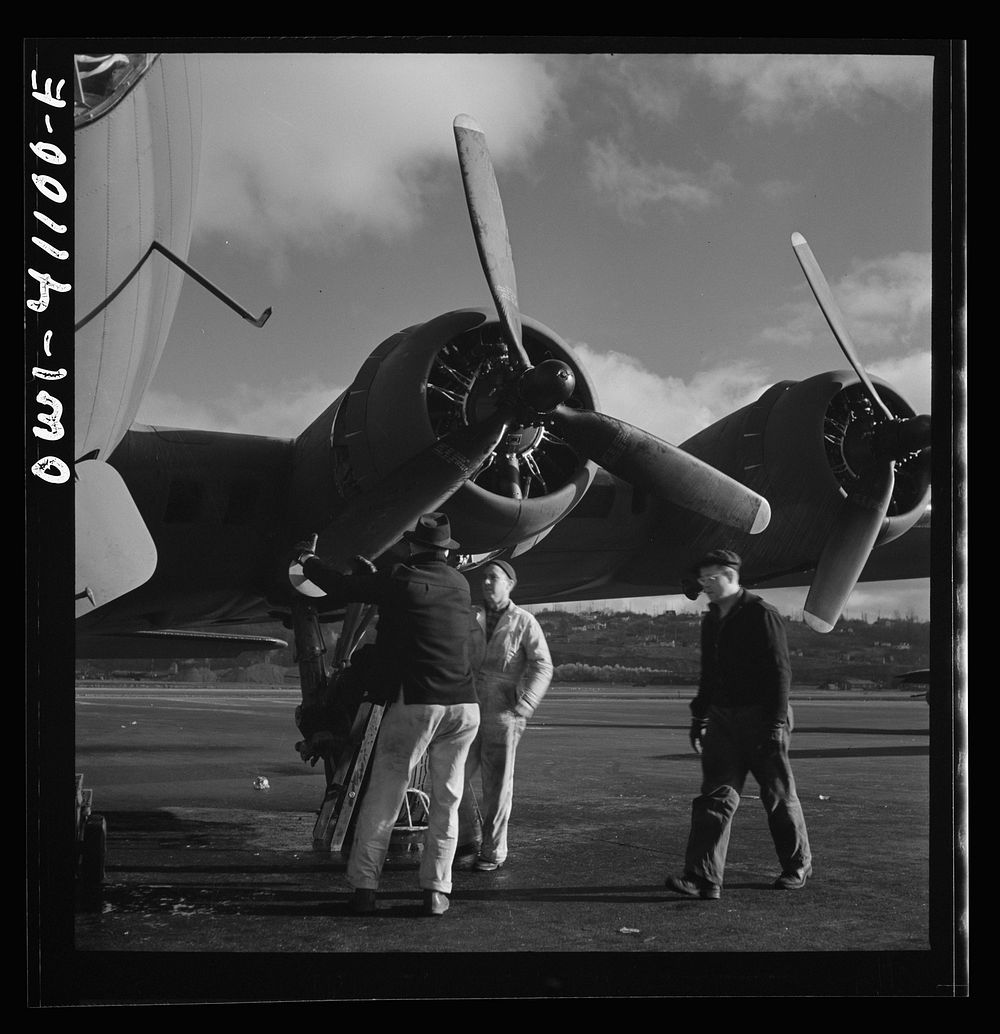 Boeing aircraft plant, Seattle, Washington. Production of B-17F (Flying Fortress) bombing planes. Lubricating and servicing…