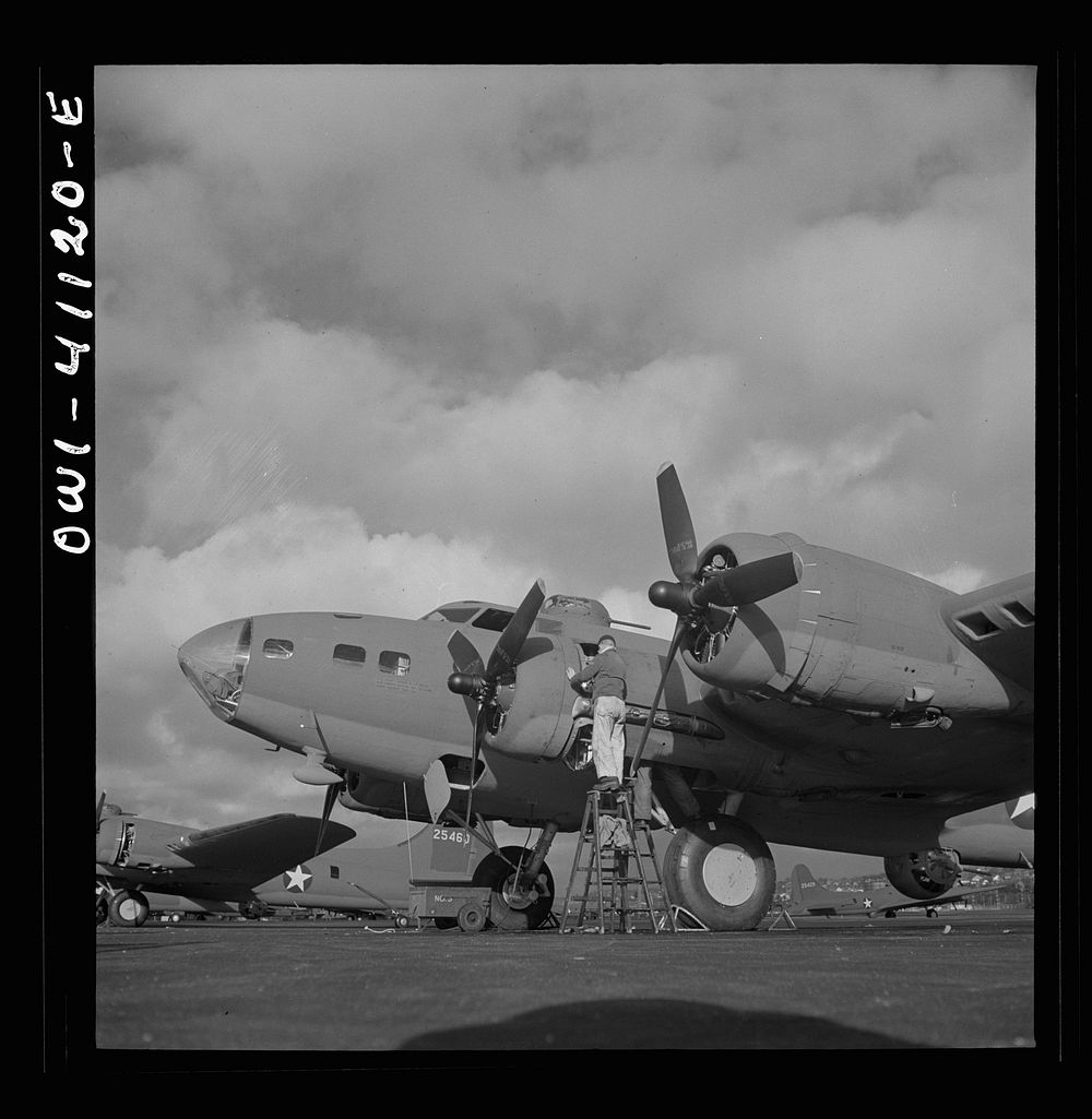 Boeing aircraft plant, Seattle, Washington. Production of B-17F (Flying Fortress) bombing planes. Lubricating and servicing…