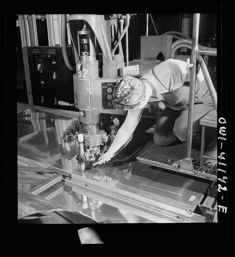 Boeing aircraft plant, Seattle, Washington. Production of B-17F (Flying Fortress) bombing planes. A spot welder. Sourced…