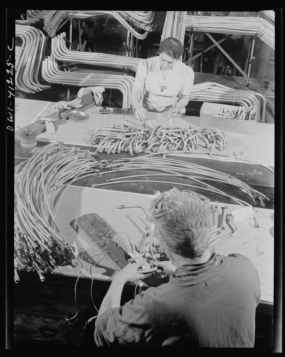 Boeing aircraft plant, Seattle, Washington. Production of B-17 (Flying Fortress) bombing planes. Tubing bent in specified…