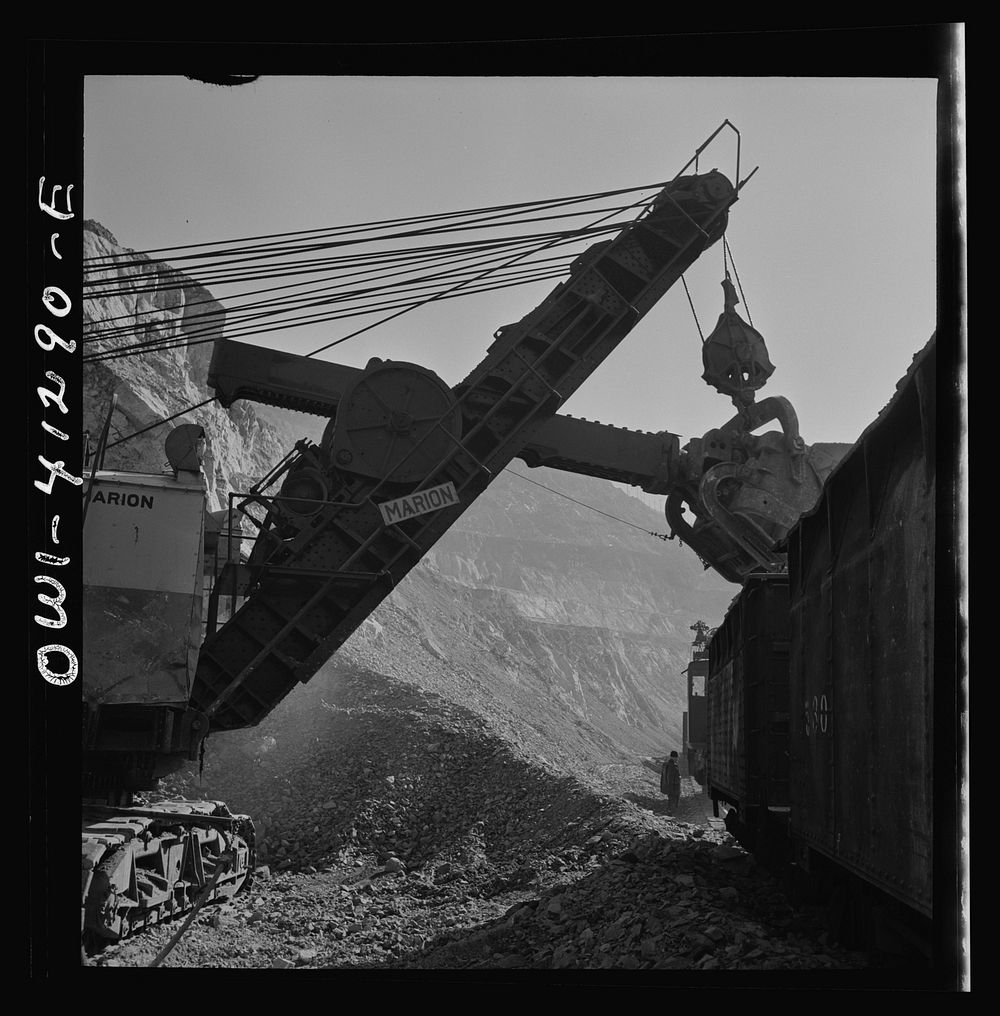 Bingham Canyon, Utah. A huge dipper loading ore into cars at an open-pit mine of the Utah Copper Company. Sourced from the…