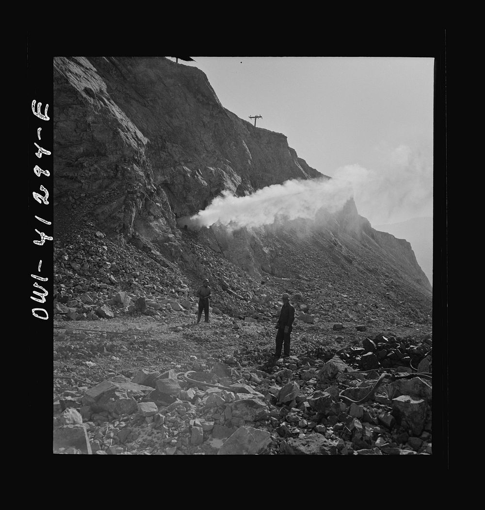 Bingham Canyon, Utah. Blasting at the open-pit mine of the Utah Copper Company at Carr Fork. Sourced from the Library of…