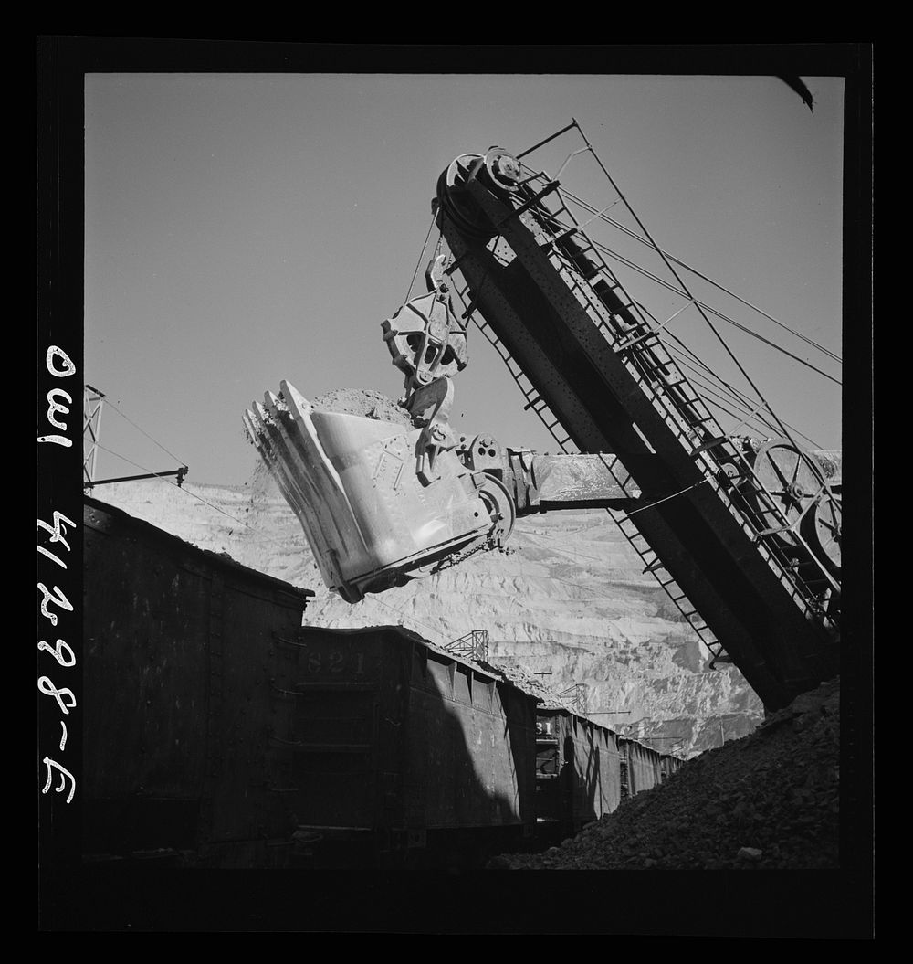 [Untitled photo, possibly related to: Bingham Canyon, Utah. Huge dipper of a shovel loading ore into cars at a mine of the…