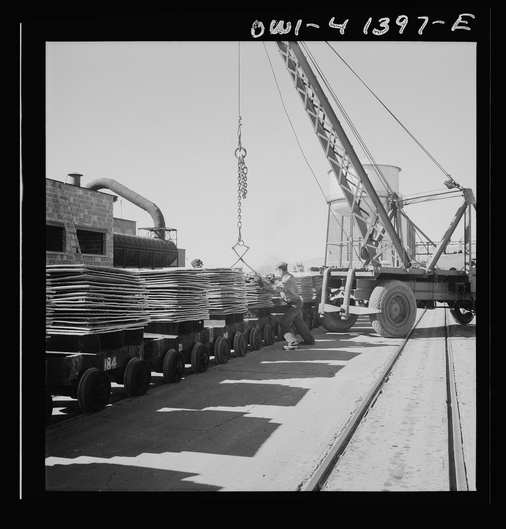 Phelps Dodge refining company, El Paso, Texas. Crane lifting a sling of copper sheets. Sourced from the Library of Congress.