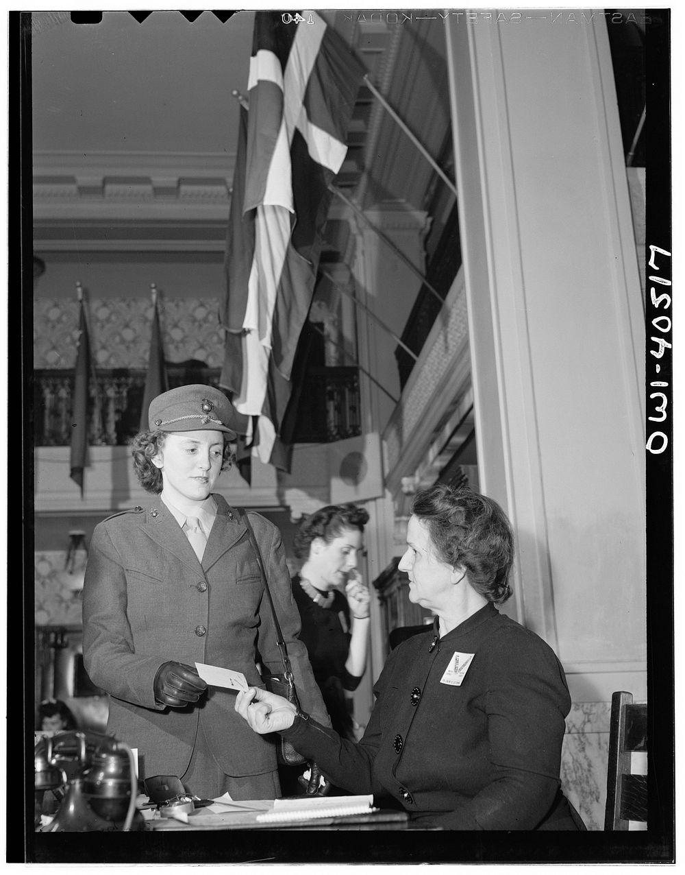 Washington, D.C. A girl Marine at the reception desk in the lobby of the United Nations service center. Sourced from the…