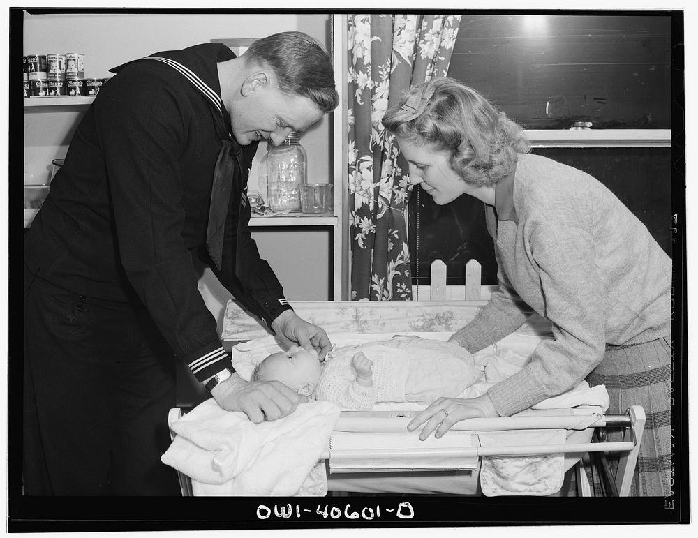 Washington, D.C. Hugh and Lynn Massman preparing to take their son from the nursery at the United Nations Service Center.…
