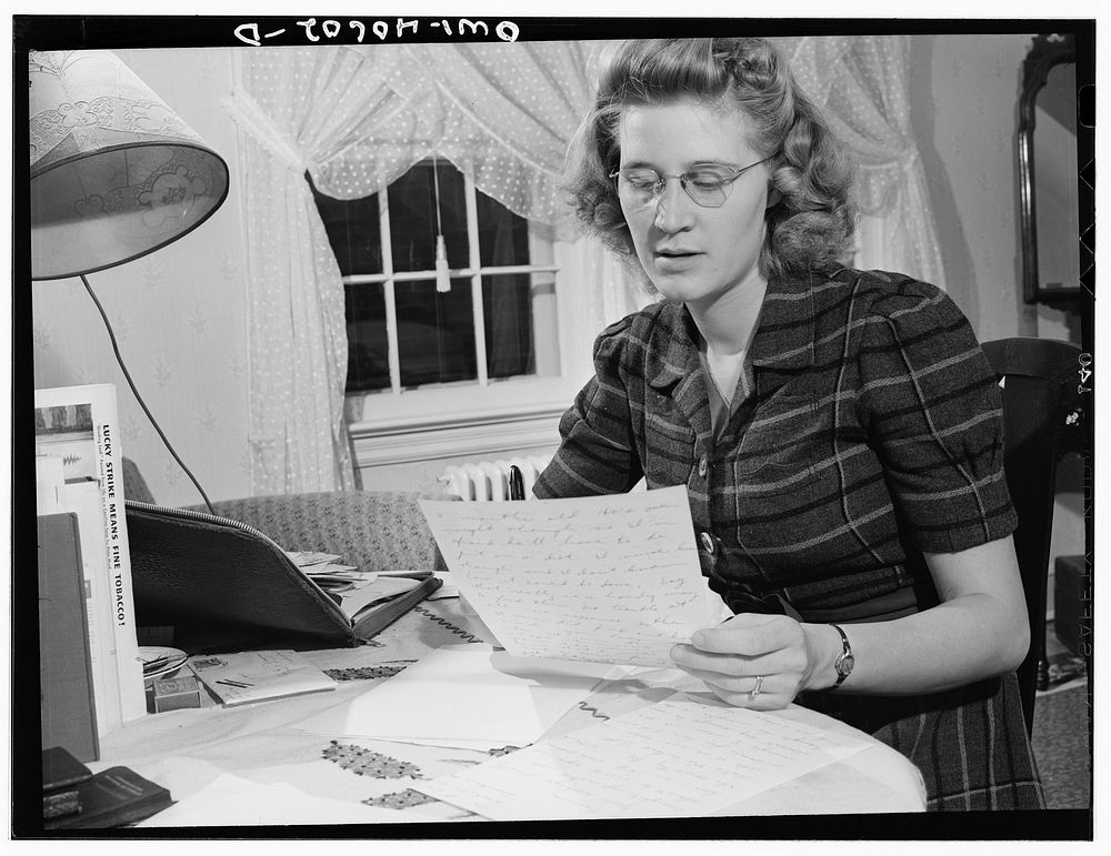 Washington, D.C. Lynn Massman, wife of a second class petty officer who is studying in Washington, writing letters while her…