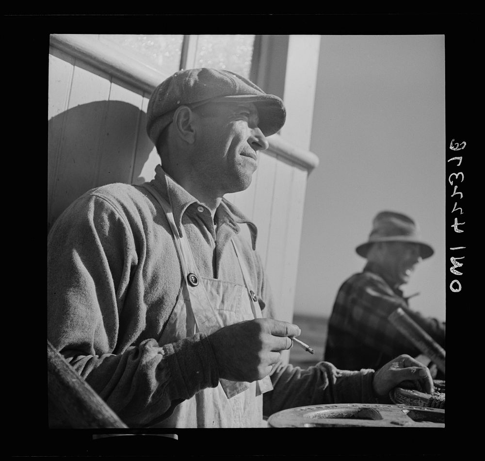 On board a fishing vessel, out from Gloucester, Massachusetts. A winch control man. Sourced from the Library of Congress.