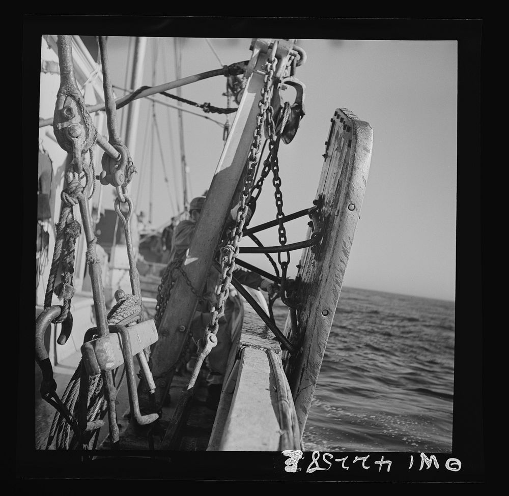 On board a fishing vessel, out from Gloucester, Massachusetts. The two otter boards which work against the current and keep…