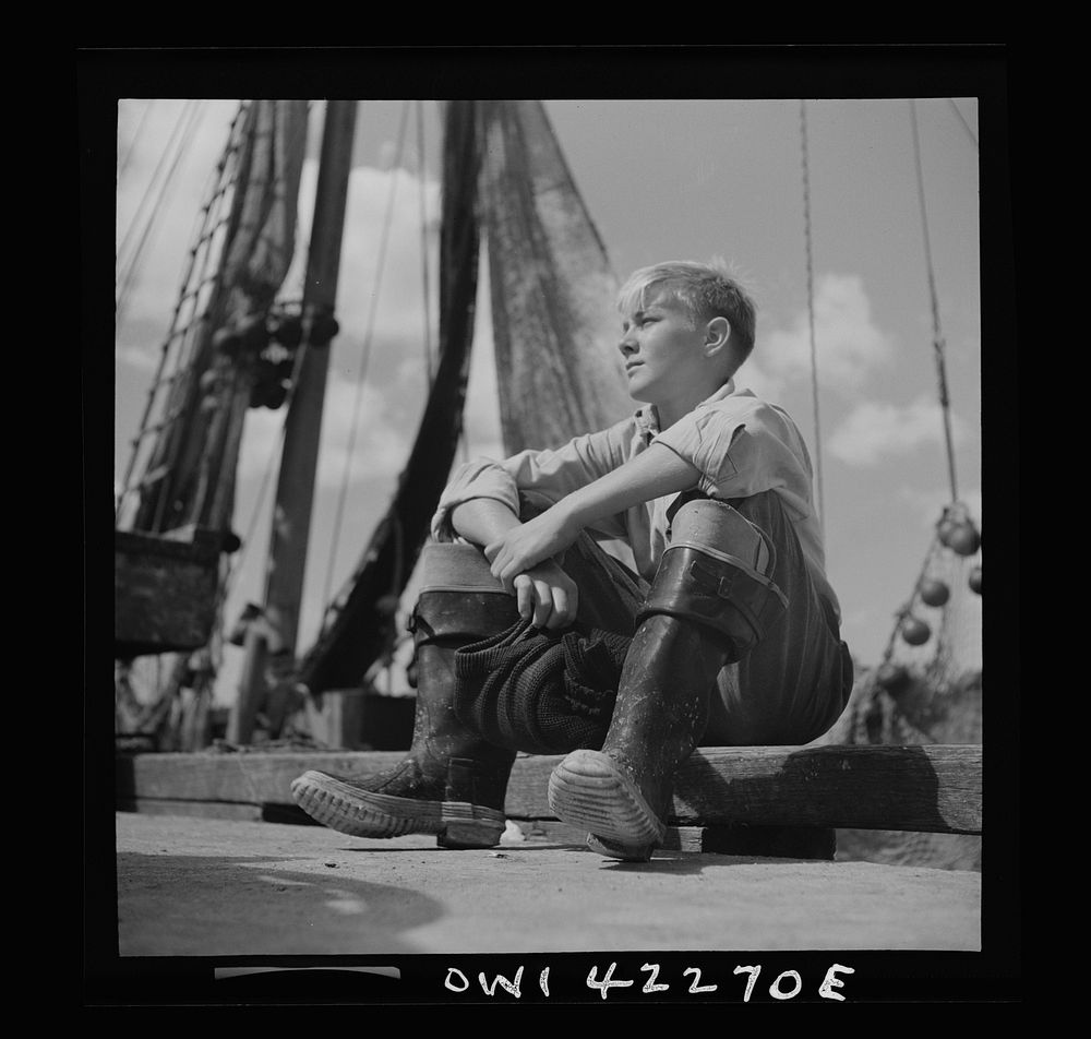 Gloucester, Massachusetts. A young Gloucester boy, probably a fisherman of tommorrow, because many of the boys follow their…