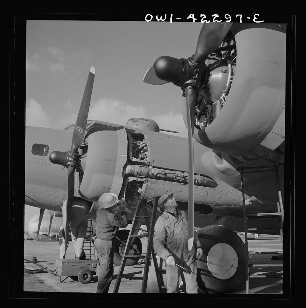 Seattle, Washington. Boeing aircraft plant. Production of B-17F (Flying Fortress) bombing planes. Lubricating and servicing…