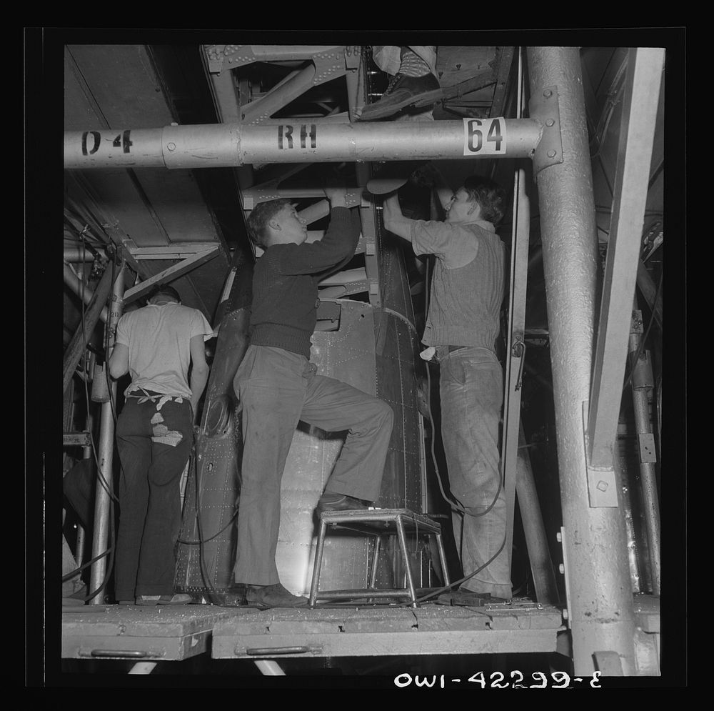 Seattle, Washington. Boeing aircraft plant. Production of B-17F (Flying Fortress) bombing planes. Riveters working on the…