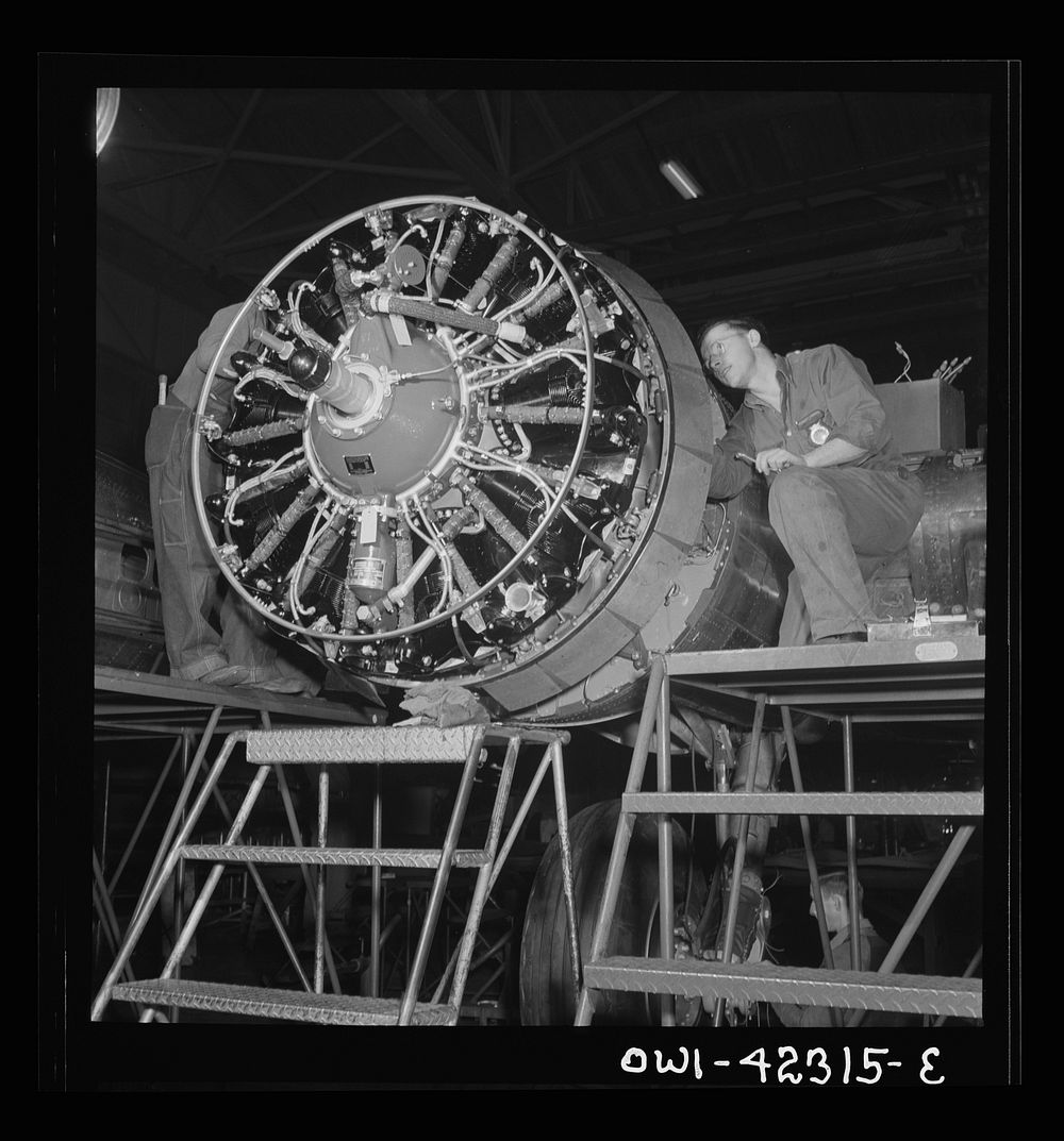 Boeing aircraft plant, Seattle, Washington. Production of B-17F (Flying Fortress) bombing planes. Workers assembling a…