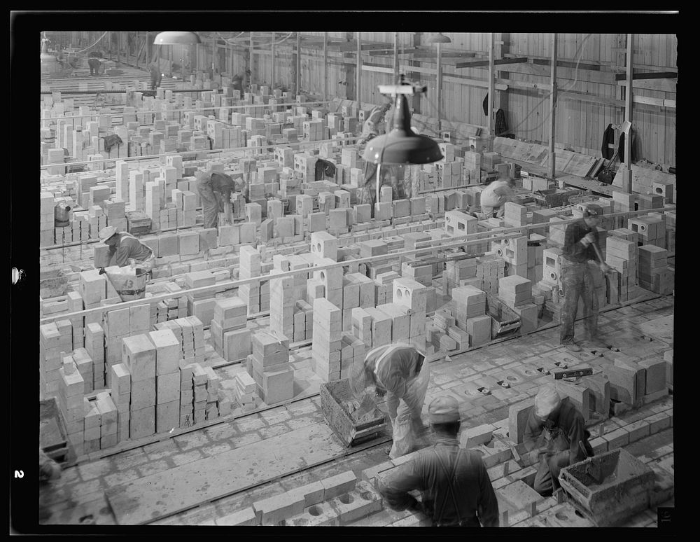 [Untitled photo, possibly related to: Columbia Steel Company at Geneva, Utah. In a weather protection shed masonry goes into…