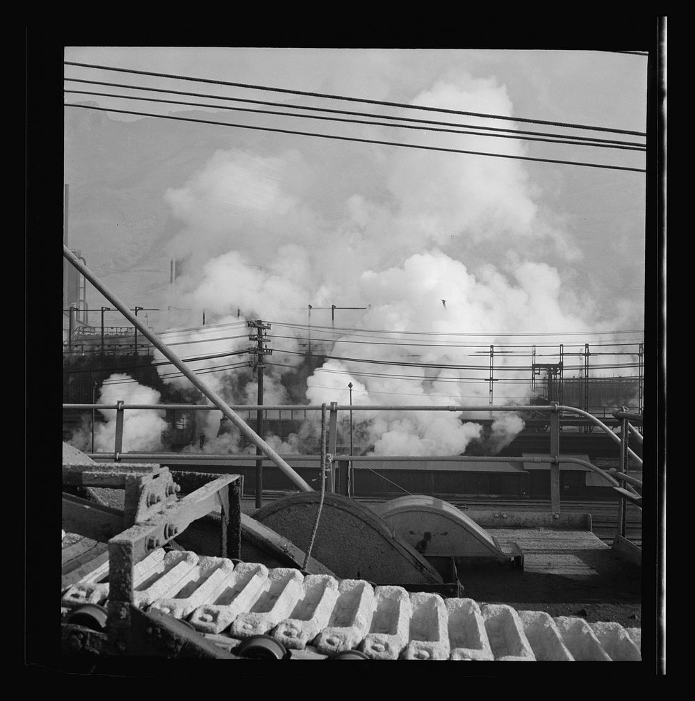 Columbia Steel Company at Ironton, Utah. Looking upon coke ovens. The steam indicates that coke is being wetted. Sourced…