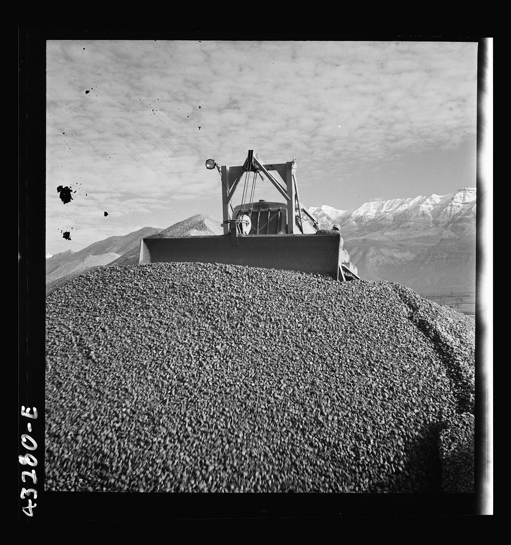 [Untitled photo, possibly related to: Columbia Steel Company at Geneva, Utah. Bulldozer handling gravel for concrete during…