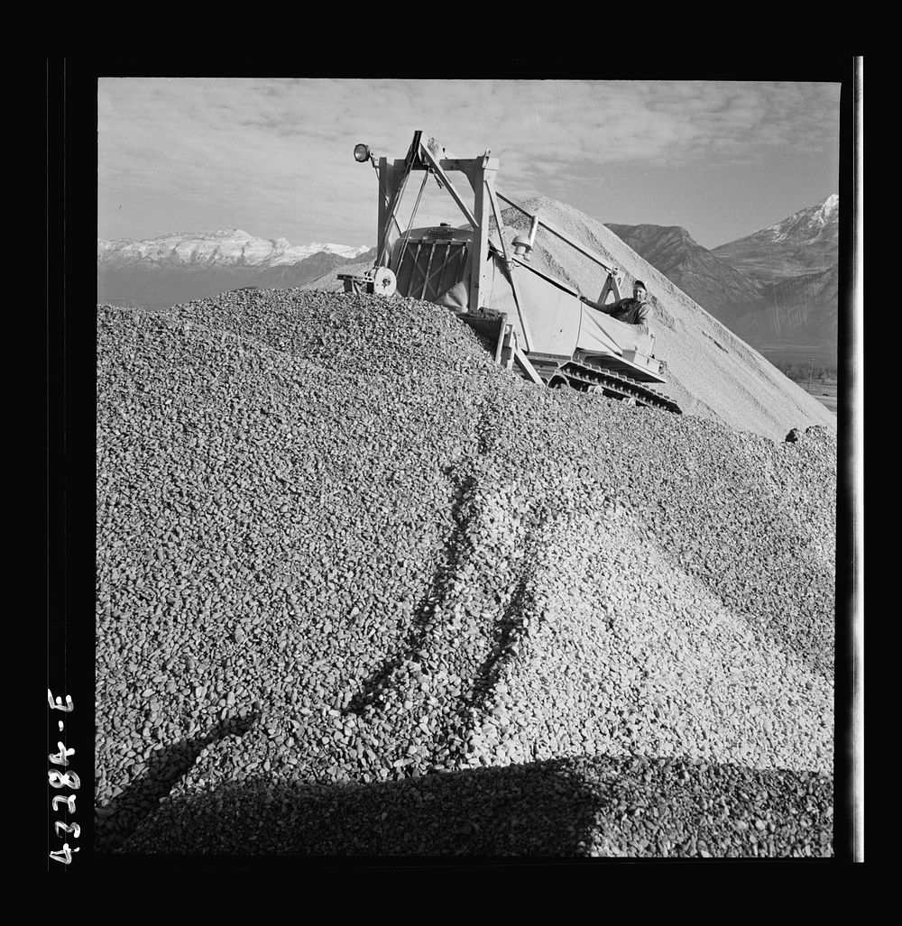[Untitled photo, possibly related to: Columbia Steel Company at Geneva, Utah. Bulldozer handling gravel for concrete during…