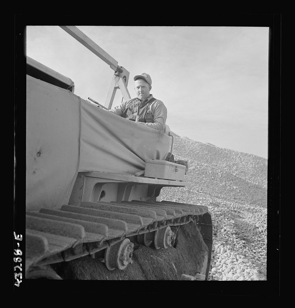 Columbia Steel Company at Geneva, Utah. Bulldozer handling gravel for concrete during the construction of a new steel mill…