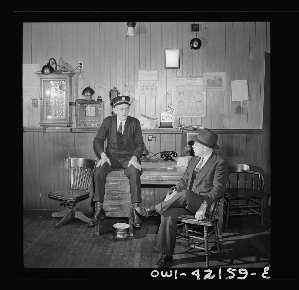Southington, Connecticut. Thomas J. Murphy, chief of the fire department, and its only salaried member, chatting with one of…
