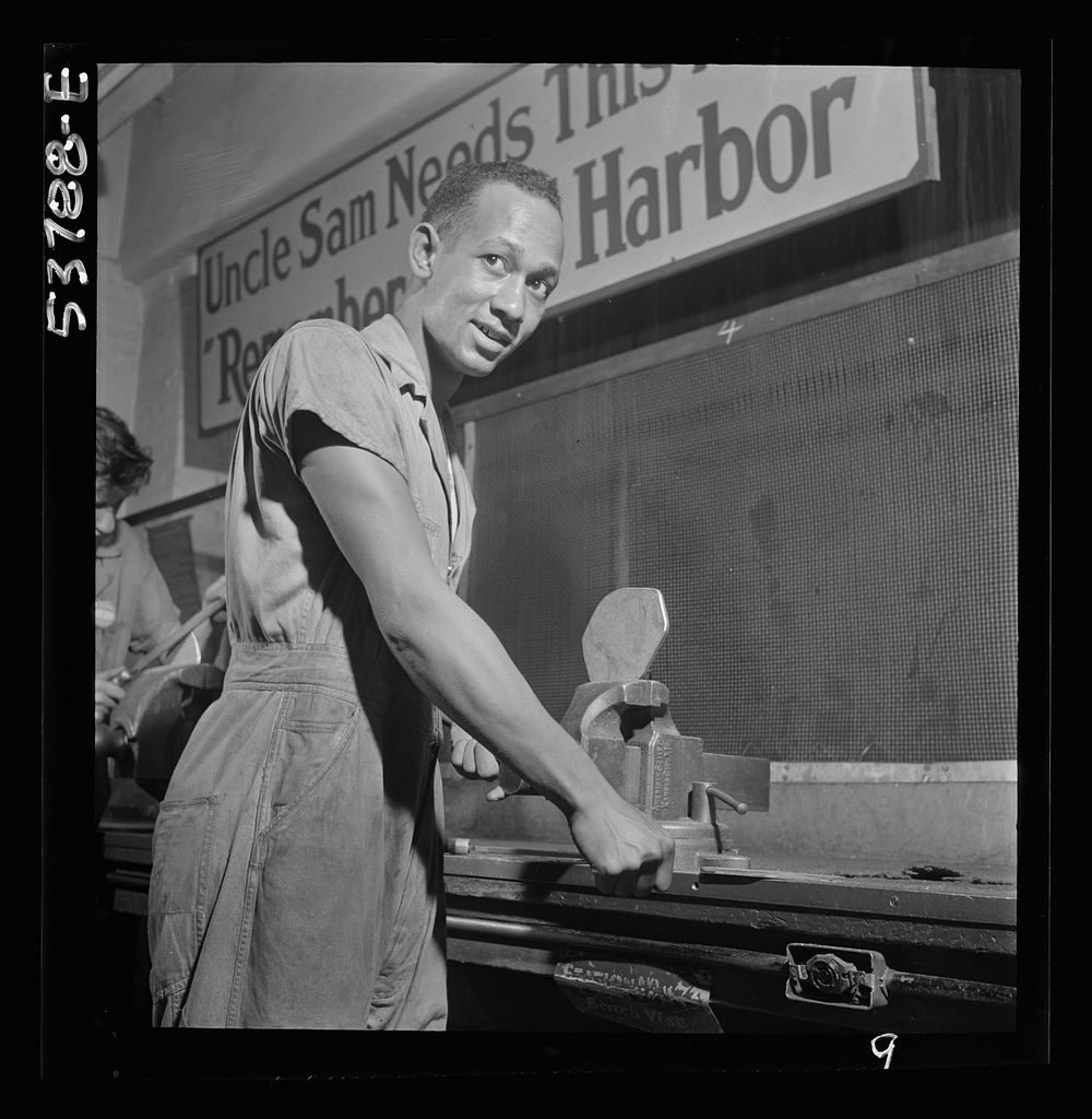 NYA (National Youth Administration) work center, Brooklyn, New York. A  bench worker, who is receiving training in machine…