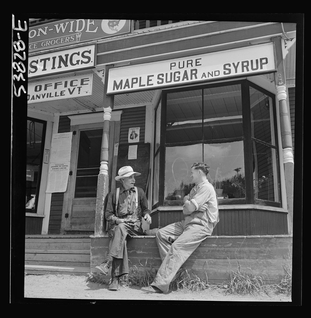 West Danville, Vermont. In front of Gilbert S. Hastings General Store and post office, Floyd Wheeler, clerk, chatting a…