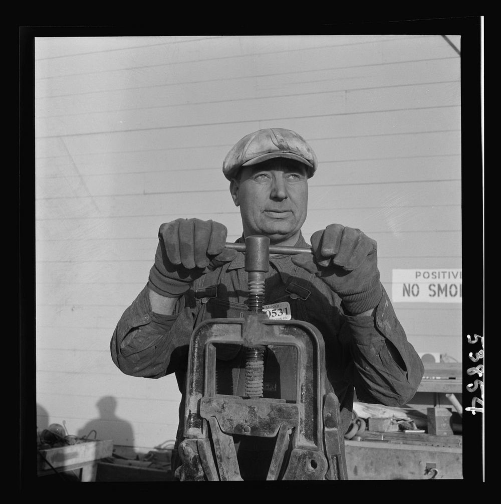 Las Vegas, Nevada. One of the construction workers at the Basic Magnesium Incorporated plant, working at the pipe vise. He…