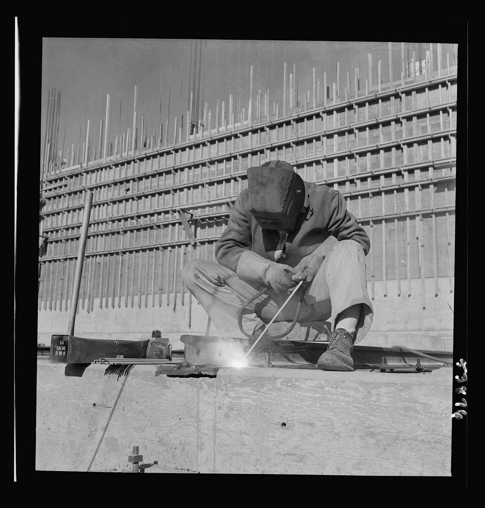 Las Vegas, Nevada. A helmeted welder busy in his part in the completion of the Basic Magnesium Incorporated plant in the…
